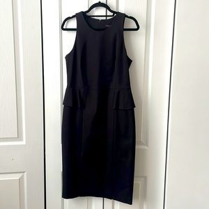 Stretch twill dress with peplum details at waist front and back. Zip back.